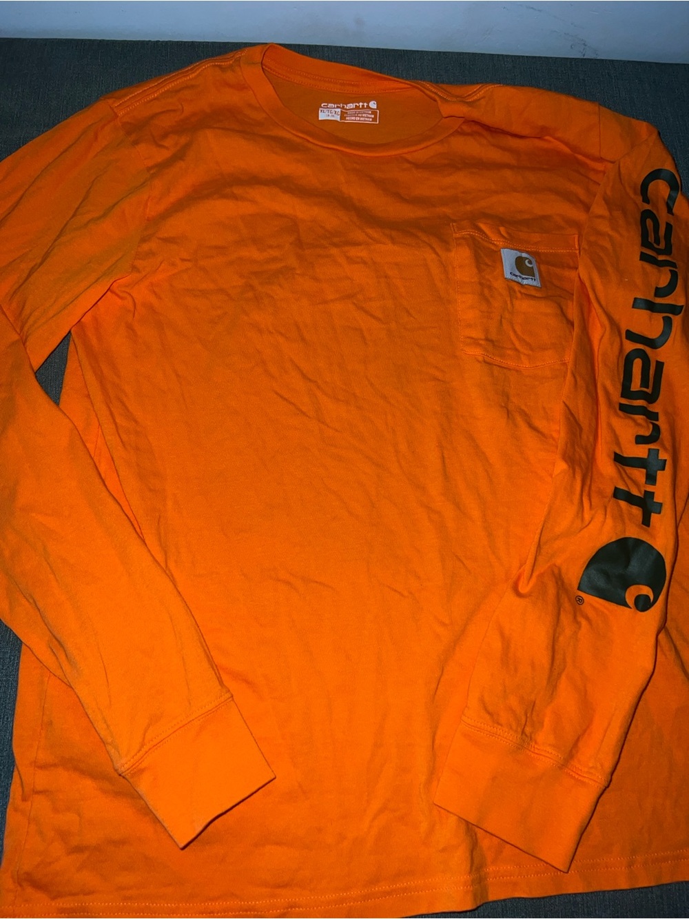 Carhartt Boy’s Long-Sleeve Pocket Tee in Bright Orange with Sleeve Logo
